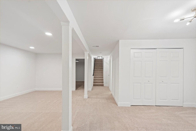 finished basement with carpet, stairs, baseboards, and recessed lighting
