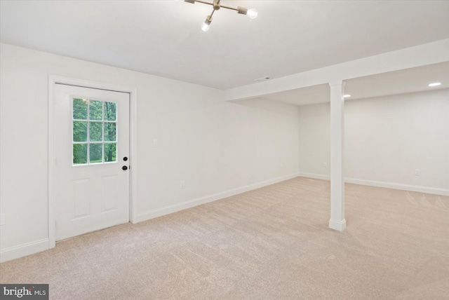 below grade area featuring carpet and baseboards