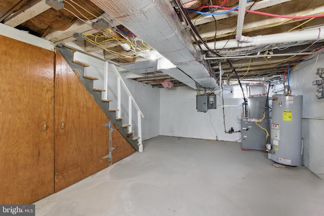 unfinished basement featuring gas water heater, stairway, electric panel, and heating unit