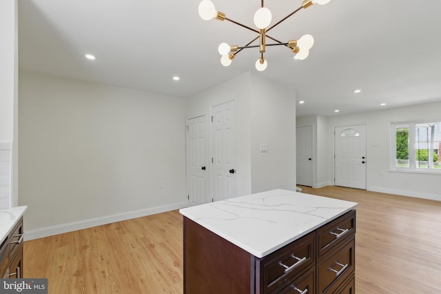 kitchen with light wood-style floors, baseboards, a chandelier, decorative light fixtures, and recessed lighting