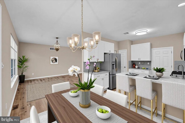 28 W Houndpack Way, Glen Mills, PA 19342 - dining space with baseboards, light wood-style flooring, and a chandelier