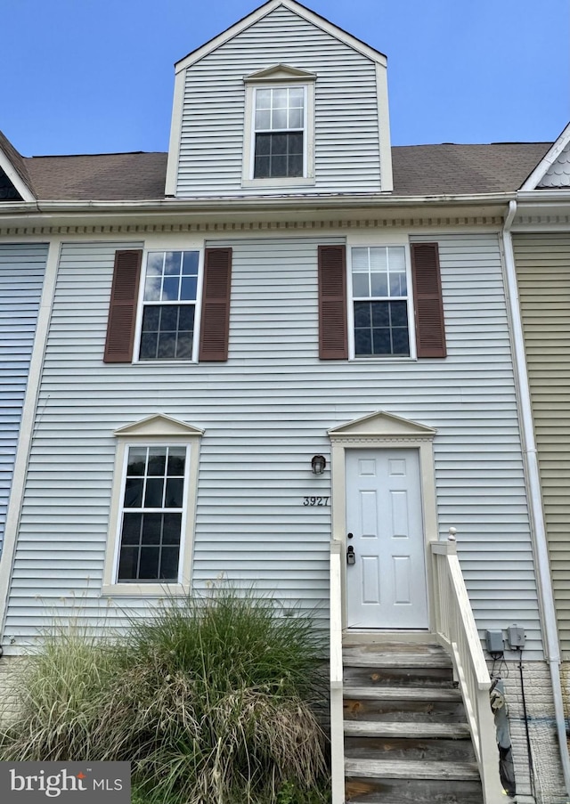 multi unit property featuring entry steps and roof with shingles