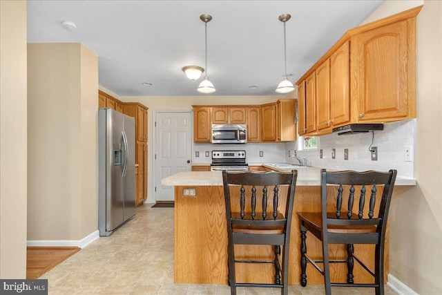 192 Antietam Dr, Waynesboro, PA 17268 - kitchen featuring appliances with stainless steel finishes, a peninsula, light countertops, decorative backsplash, and baseboards