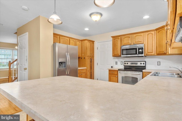 192 Antietam Dr, Waynesboro, PA 17268 - kitchen featuring stainless steel appliances, a sink, a peninsula, light countertops, and hanging light fixtures