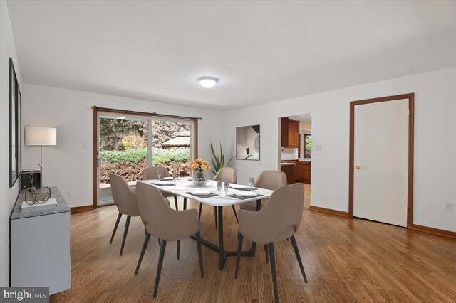 dining room featuring light wood-type flooring and baseboards