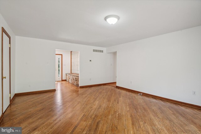 spare room with wood finished floors and baseboards