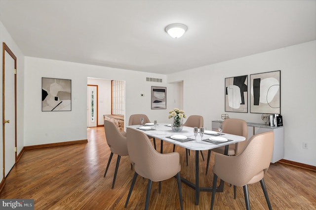 dining area featuring wood finished floors and baseboards