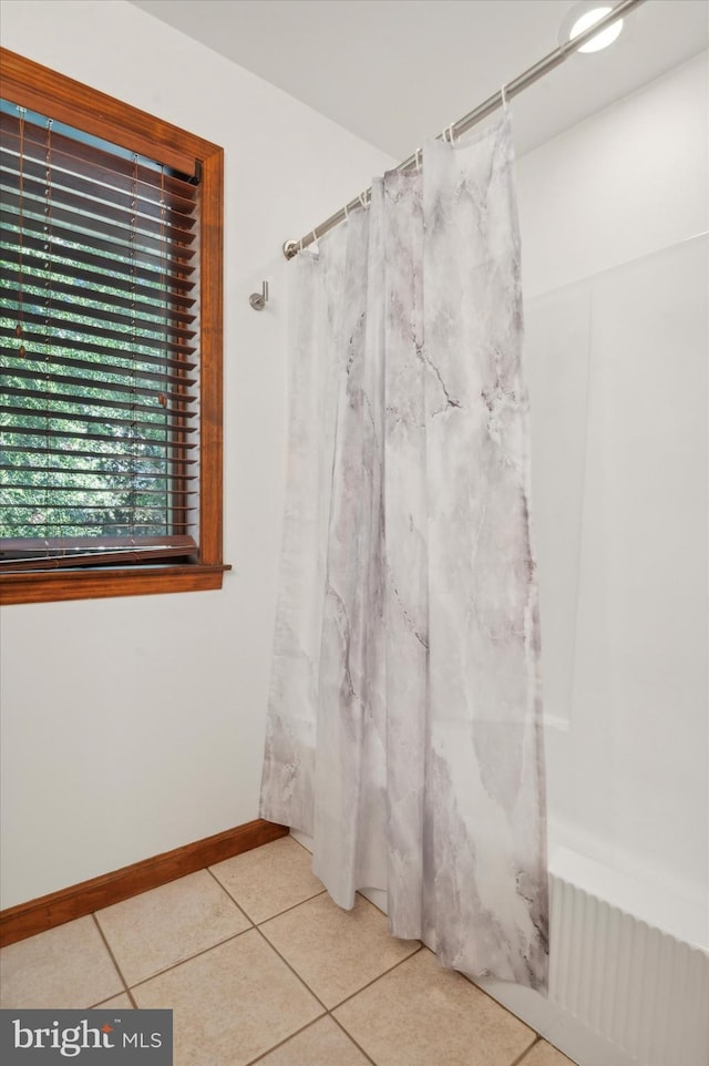 full bath with tile patterned floors and curtained shower