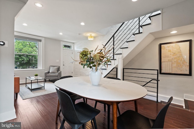 dining space with baseboards, recessed lighting, stairs, and wood finished floors
