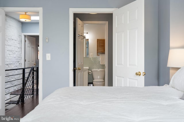 bedroom with wood finished floors and ensuite bathroom