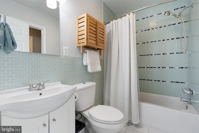 full bathroom featuring toilet, shower / bath combo, vanity, tile patterned flooring, and tile walls