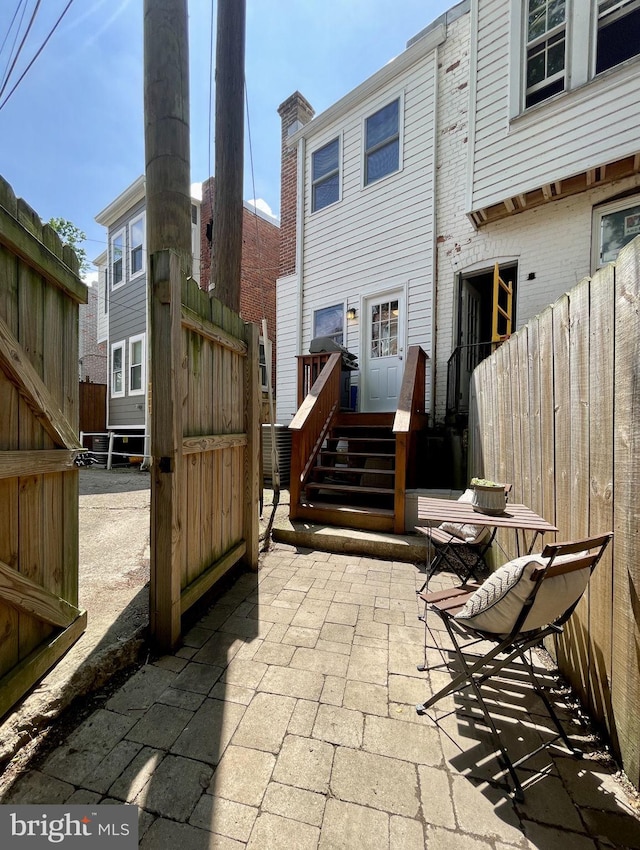 rear view of house featuring fence and a patio area