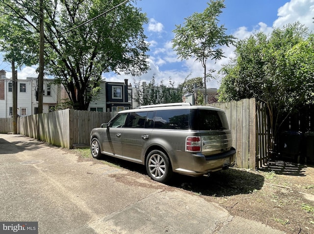 view of parking / parking lot with fence