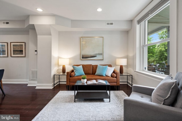 living room featuring wood finished floors, baseboards, and recessed lighting