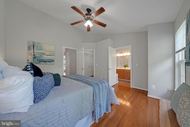 5948 Edgehill Ct, Alexandria, VA 22303 - bedroom with light wood-style flooring, vaulted ceiling, baseboards, a ceiling fan, and a spacious closet