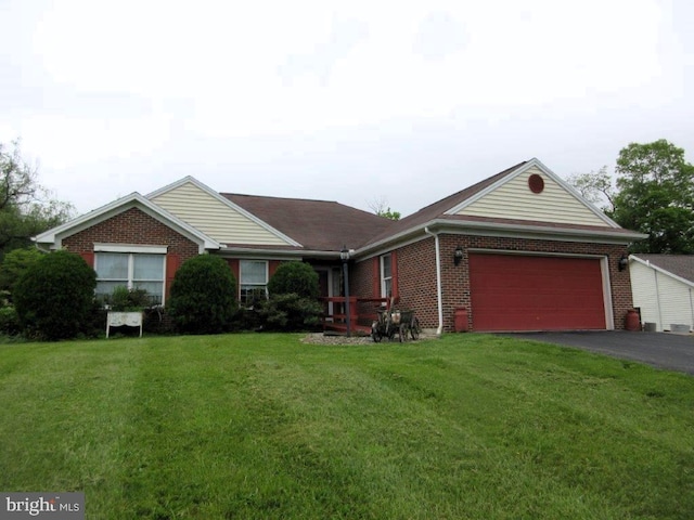 155 Wagon Wheel Ln, Mifflintown, PA 17059 - single story home featuring asphalt driveway, brick siding, a front lawn, and an attached garage