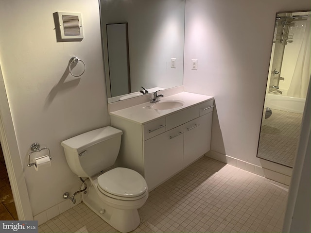 bathroom featuring toilet, tile patterned floors, and vanity