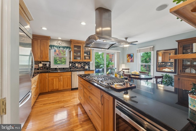 800 S Charles St, Baltimore, MD 21230 - kitchen featuring appliances with stainless steel finishes, healthy amount of natural light, dark countertops, island range hood, and recessed lighting