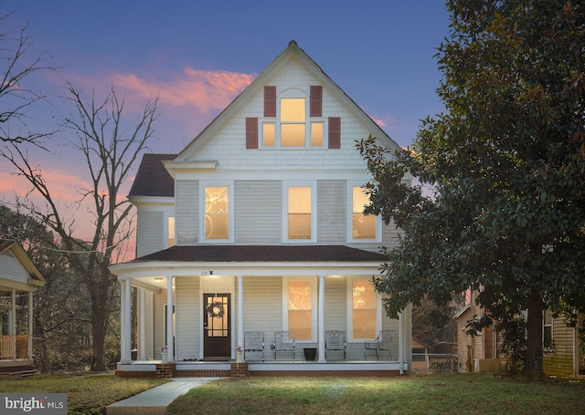 113 W Main St, Wakefield, VA 23888 - view of front of house with a porch, a shingled roof, and a lawn