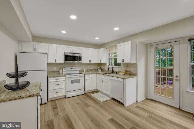 21850 Goldstone Ter, Sterling, VA 20164 - kitchen with white appliances, a sink, light wood-style flooring, white cabinetry, and light stone countertops