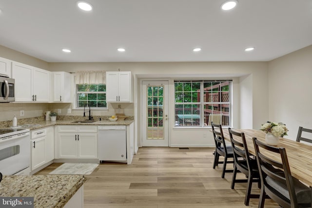21850 Goldstone Ter, Sterling, VA 20164 - kitchen featuring white appliances, a sink, white cabinets, light wood-style floors, and light stone countertops
