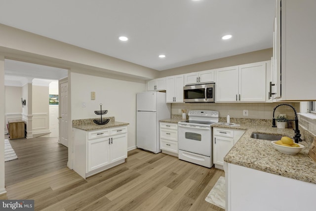 21850 Goldstone Ter, Sterling, VA 20164 - kitchen with white appliances, a sink, light wood finished floors, white cabinetry, and light stone counters
