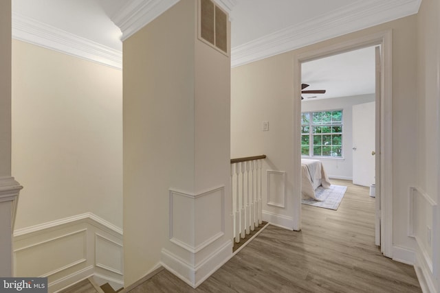 21850 Goldstone Ter, Sterling, VA 20164 - hall with an upstairs landing, wood finished floors, ornamental molding, and a wainscoted wall