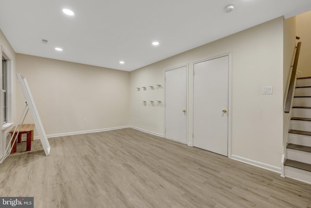 21850 Goldstone Ter, Sterling, VA 20164 - basement featuring stairs, light wood-style floors, recessed lighting, and baseboards