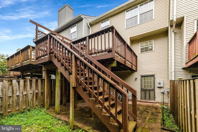21850 Goldstone Ter, Sterling, VA 20164 - rear view of property featuring a fenced backyard, a wooden deck, stairway, and a chimney
