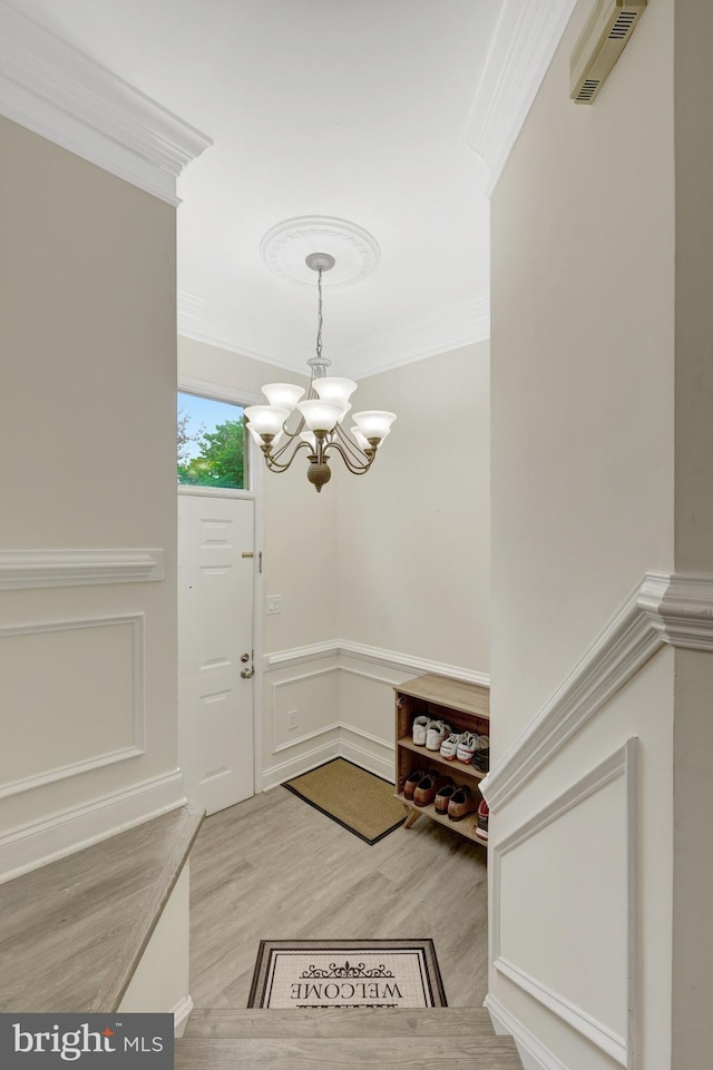 21850 Goldstone Ter, Sterling, VA 20164 - entryway with ornamental molding, a chandelier, and light wood finished floors
