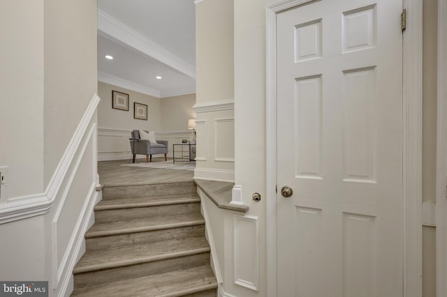 21850 Goldstone Ter, Sterling, VA 20164 - stairs featuring crown molding, a decorative wall, wood finished floors, wainscoting, and recessed lighting