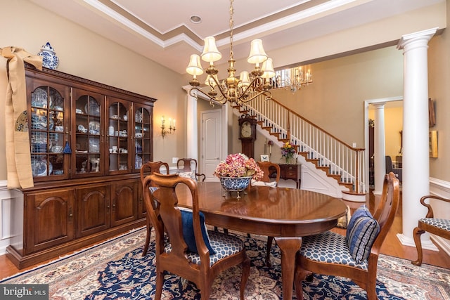 267 Goldenrod Dr, Upper Gwynedd, PA 19446 - dining area with stairway, a chandelier, ornate columns, crown molding, and wood finished floors