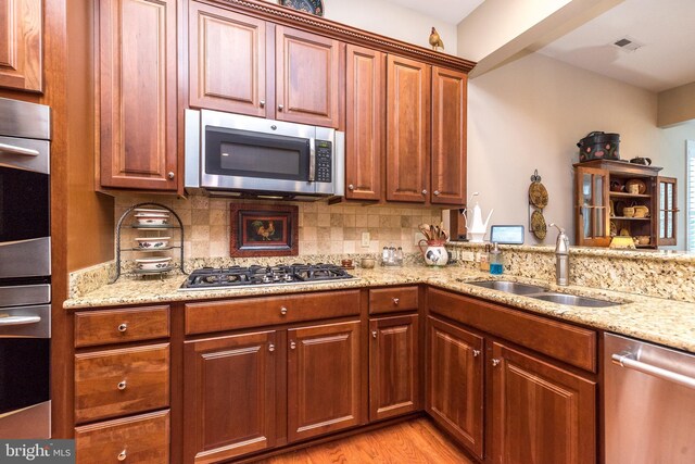 267 Goldenrod Dr, Upper Gwynedd, PA 19446 - kitchen with stainless steel appliances, a sink, backsplash, and light stone counters