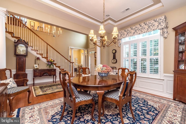 267 Goldenrod Dr, Upper Gwynedd, PA 19446 - dining area with a chandelier, crown molding, stairs, wood finished floors, and a wainscoted wall
