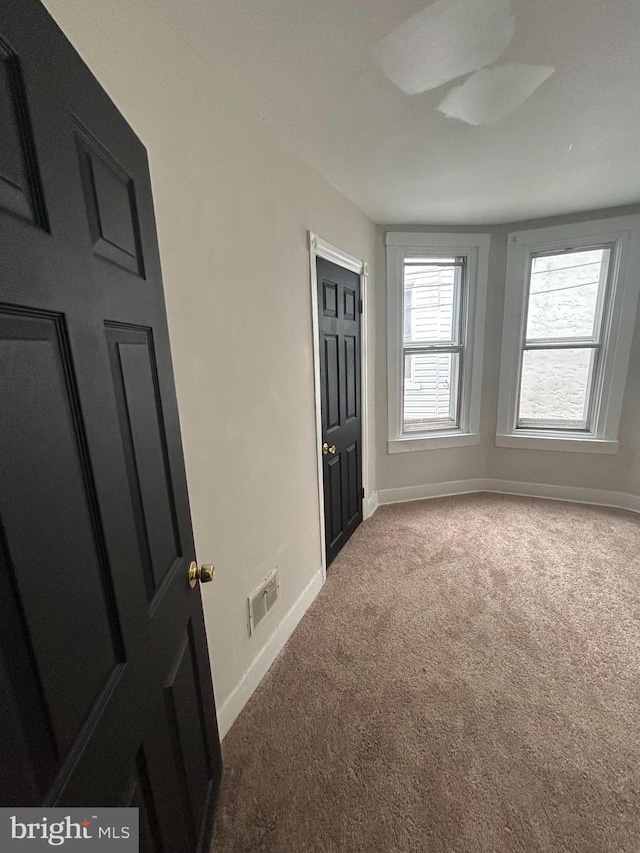 unfurnished bedroom with carpet and baseboards