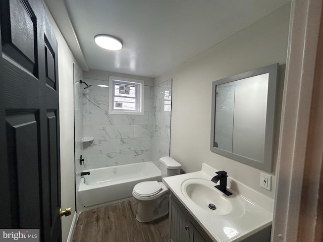 bathroom with wood finished floors, toilet, vanity, and shower / tub combination