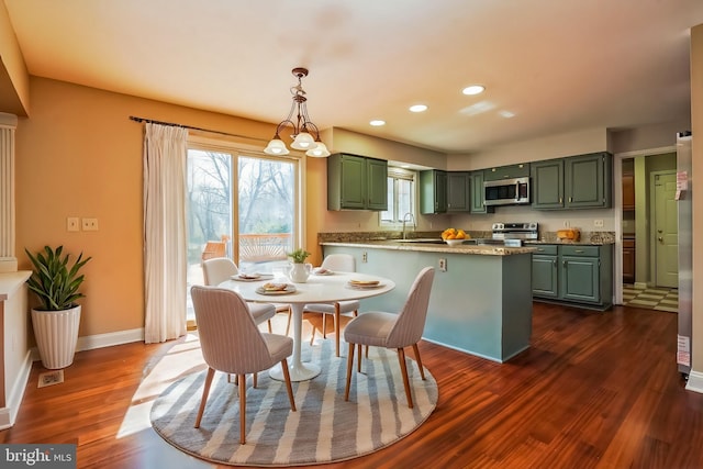 dining room with dark wood-style flooring, recessed lighting, and baseboards
