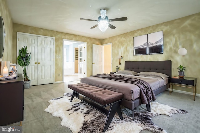 carpeted bedroom with baseboards, a closet, and a ceiling fan