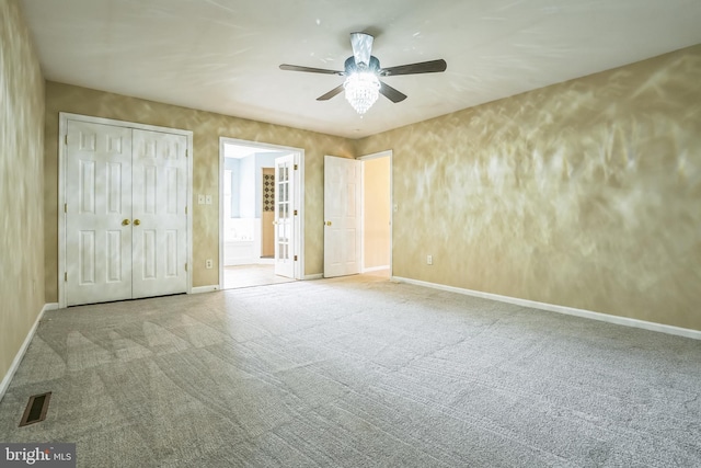 unfurnished bedroom featuring carpet, baseboards, a closet, and ceiling fan