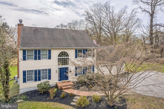 colonial home featuring a chimney