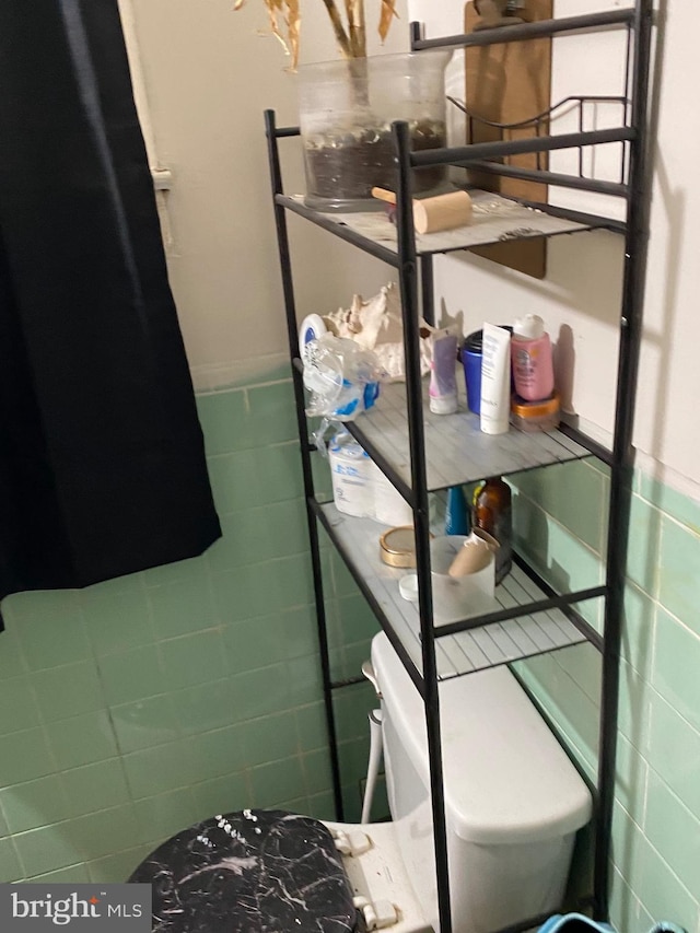 5336 Race St, Philadelphia, PA 19139 - bathroom featuring tile walls, toilet, and a wainscoted wall
