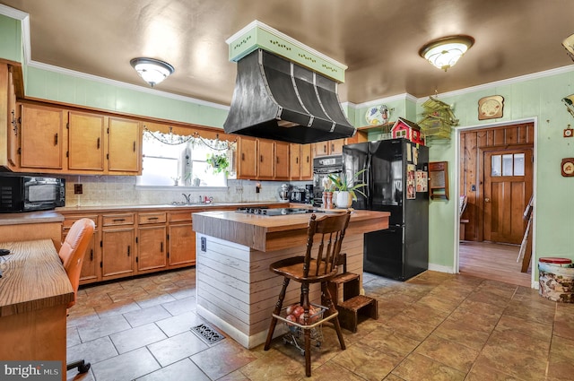 6126 Taylor St, Chincoteague Island, VA 23336 - kitchen with black appliances, crown molding, decorative backsplash, a sink, and custom exhaust hood