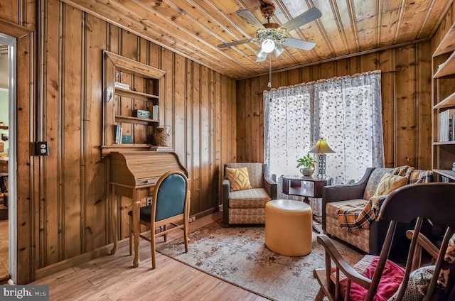 6126 Taylor St, Chincoteague Island, VA 23336 - living area with wood walls, wooden ceiling, a ceiling fan, wood finished floors, and baseboards