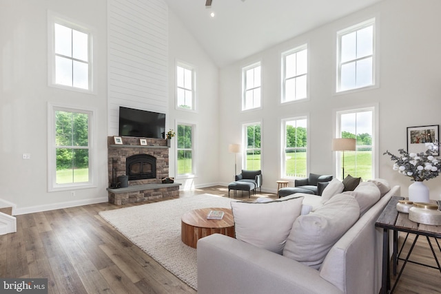 3471 Bullfrog Rd, Taneytown, MD 21787 - living area featuring high vaulted ceiling, a stone fireplace, wood finished floors, baseboards, and recessed lighting