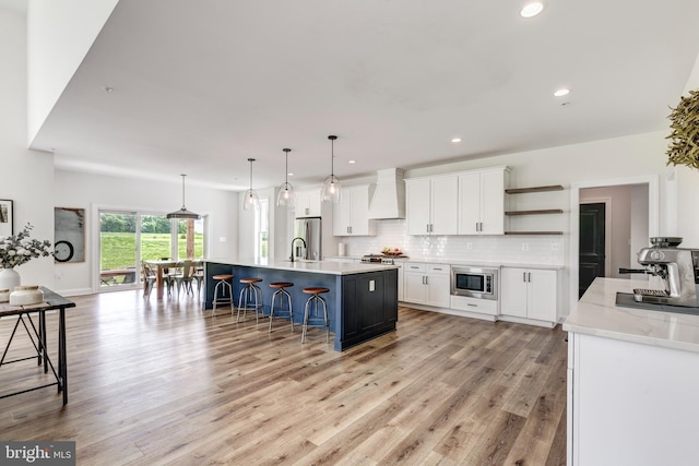 3471 Bullfrog Rd, Taneytown, MD 21787 - kitchen with appliances with stainless steel finishes, open shelves, a kitchen bar, white cabinets, and premium range hood