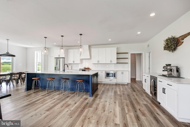 3471 Bullfrog Rd, Taneytown, MD 21787 - kitchen with stainless steel appliances, wine cooler, premium range hood, a sink, and a kitchen breakfast bar