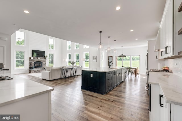 3471 Bullfrog Rd, Taneytown, MD 21787 - kitchen with a sink, open floor plan, a large island, a stone fireplace, and recessed lighting