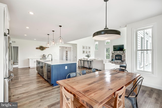 3471 Bullfrog Rd, Taneytown, MD 21787 - dining space with light wood-type flooring, a stone fireplace, plenty of natural light, and recessed lighting