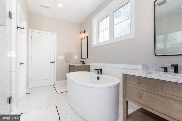 3471 Bullfrog Rd, Taneytown, MD 21787 - bathroom with a freestanding tub, two vanities, a wainscoted wall, and a shower
