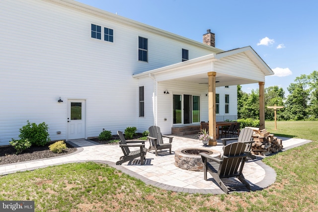 3471 Bullfrog Rd, Taneytown, MD 21787 - rear view of house with an outdoor fire pit, a patio, a yard, and a chimney
